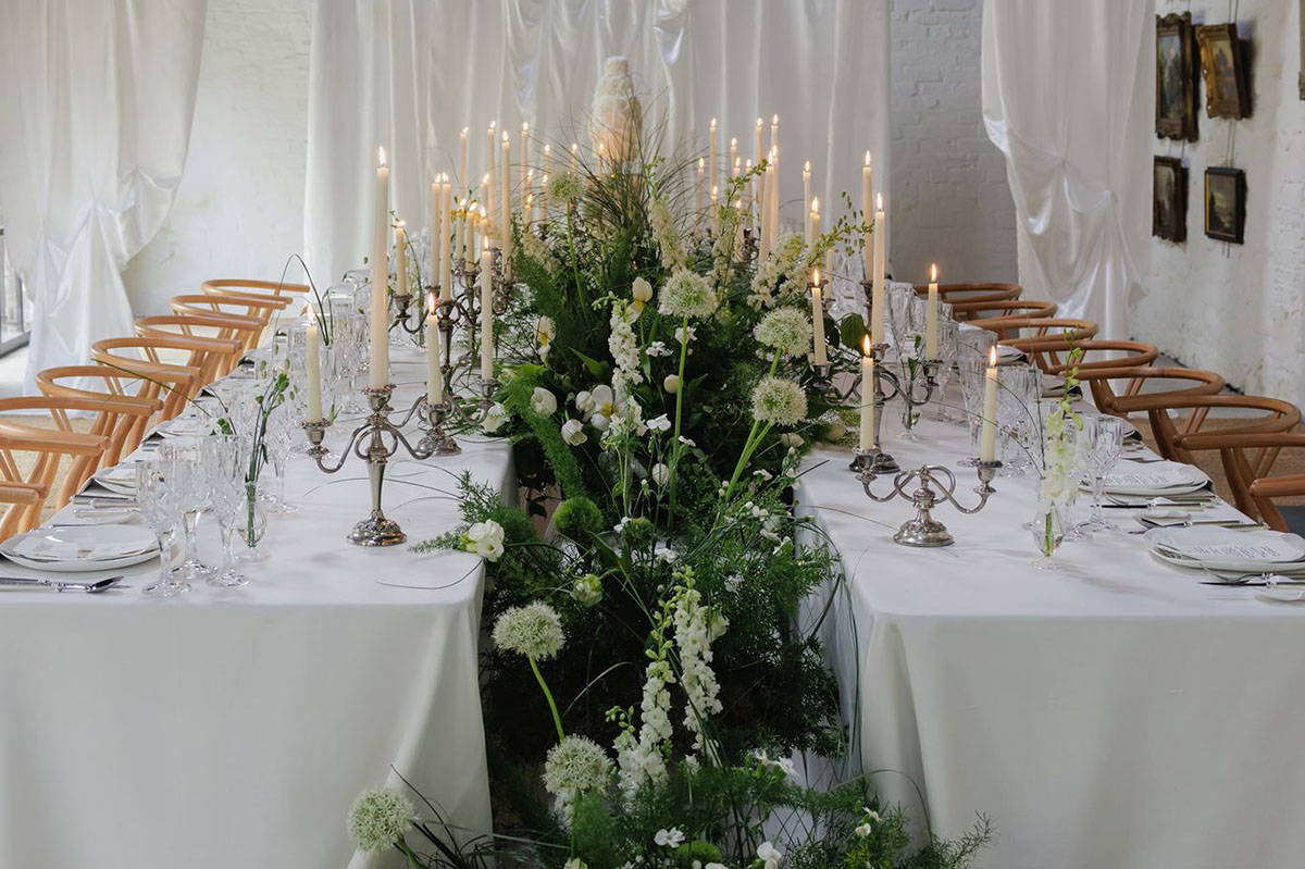 Event florals elegantly placed around event table Woodhill Park Estate